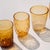 Handmade colored tumblers in mass-colored glass, blown in light shades with a spiral of "lattimo" glass threads applied...