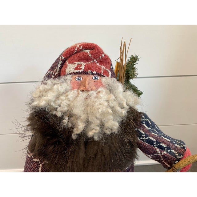 This charming folk art Santa Claus, handmade by artist Paul Gordon, is sure to add character to any seasonal display. The...