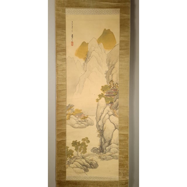 Japanese landscape scroll, a finely drawn and detailed mountain landscape in colored inks on silk, mounted on shimmering,...