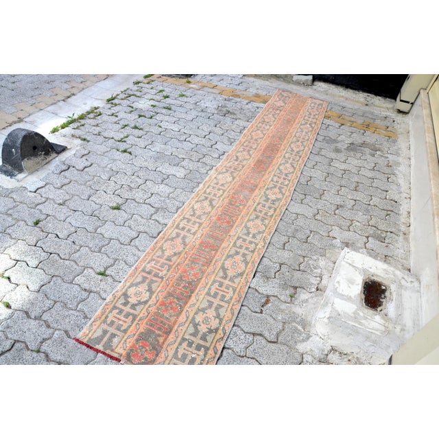 This is a vintage Turkish Oushak rug from the 1960s. The piece was hand-knotted.