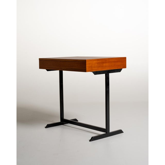 Modernist writing desk with a rectangular teak top and case, featuring two handleless drawer fronts. Simple black-painted...