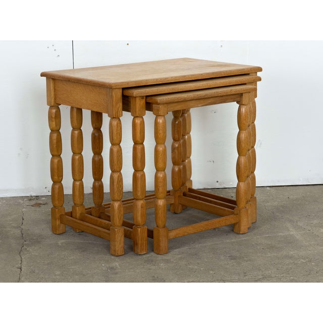 This set of three nesting tables is executed in the manner of Henning Kjærnulf, likely produced in Denmark during the...