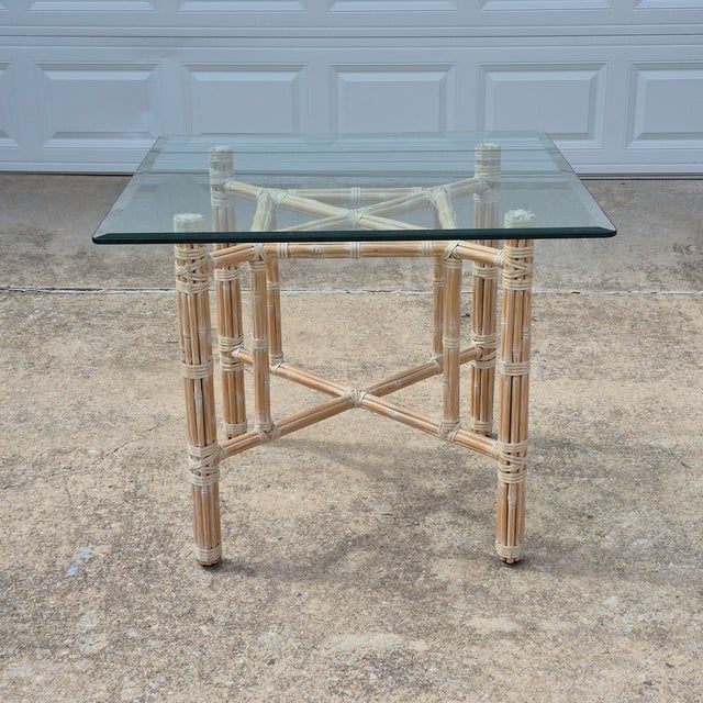 This vintage organic modern McGuire attributed dining table measures 36" square and 28.75" tall. The dining table features...