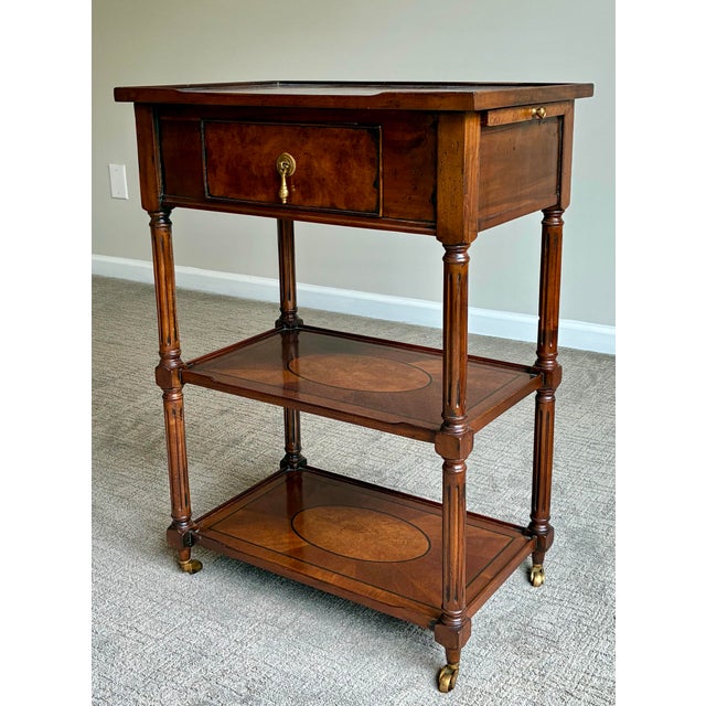 An elegant traditional occasional or side table crafted in richly toned mahogany with finely detailed inlaid oval...