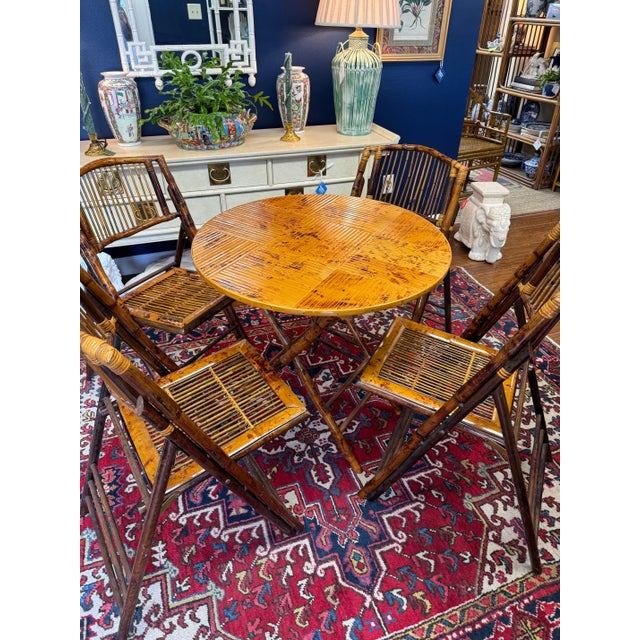 This is a wonderfully chic and practical burnt bamboo dining set with a beautiful tortoiseshell finish. The table and...