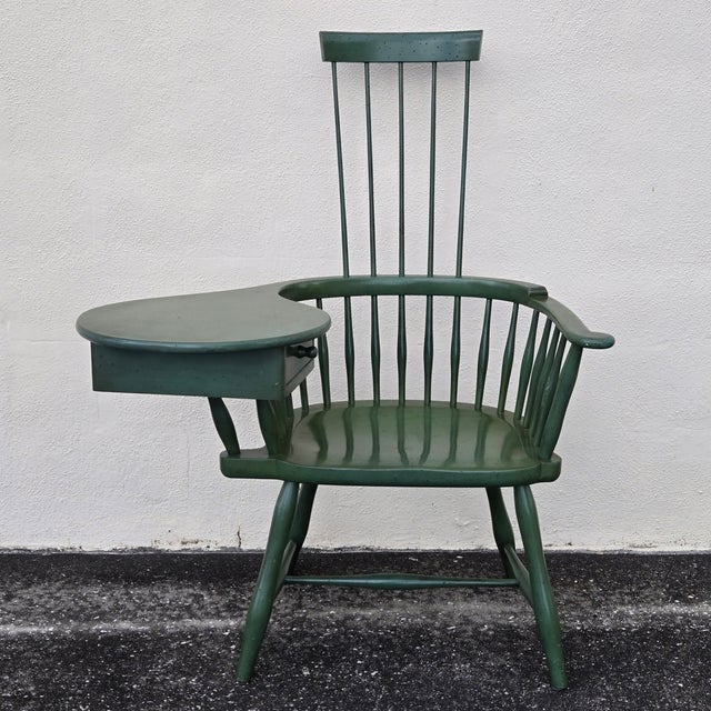 This mid-century comb back traditional Windsor style chair was built with a small desktop on the right arm, complete with...