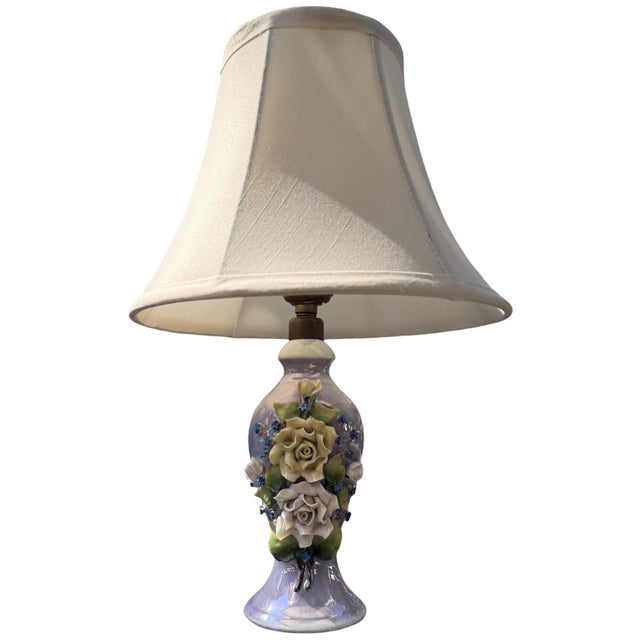 Delicate vintage German porcelain table lamp featuring a softly iridescent lavender-toned body adorned with dimensional...