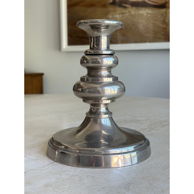 A classically sculptural candlestick by Godinger, featuring a turned stem with stacked ring and bobbin detailing in a...