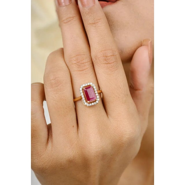 This is part of Chairish’s Fine Jewelry assortment. Long Octagon Cut Red Ruby Halo Diamond Wedding Ring in 18K Gold...