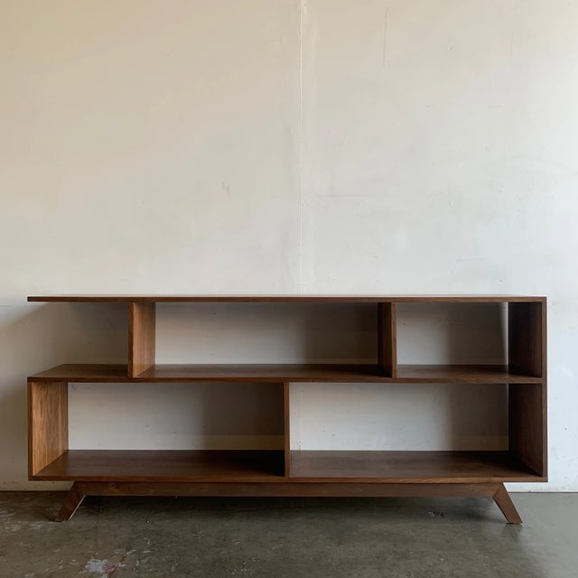 W72 D13 H32 Walnut bookcase made in a mix of solid and walnut veneer. Item is structurally sound and sturdy.