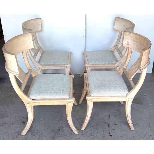 Tell me about this Set of four neoclassical grey and White Polychromed Klismos Chairs, late 20th century. The backrest has...