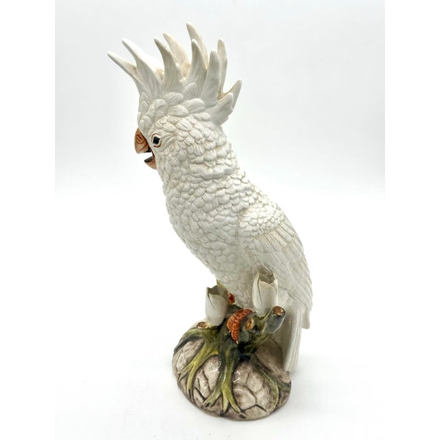 Striking vintage Ethan Allen Italian porcelain cockatoo sculpture, featuring a beautifully modeled white cockatoo perched...