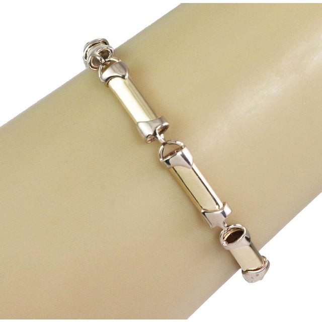 This Long Tube 14k Two Tone Gold Link Bracelet is a vintage piece of fine jewelry that exudes a classic and timeless...