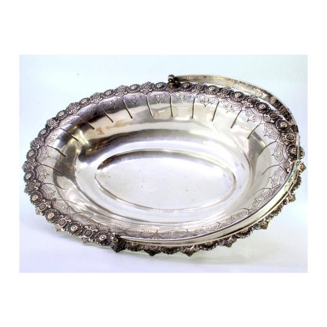 Silver Fruit Bowl with Reliefs, Handle and Feet, in Very Good conditions. Designed 1890 to 1919 This piece has an...