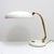 Wonderful table lamp by Hillebrand, 1960, in white and brass, on/off switch at the base, shade and arm are adjustable,...