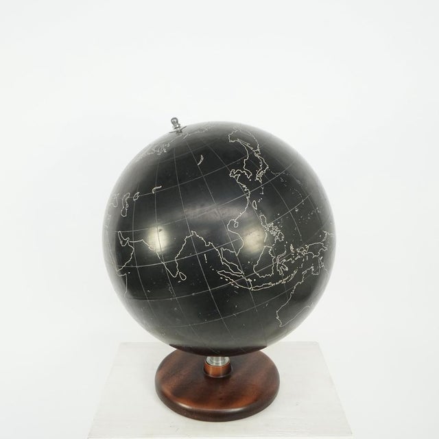 Black lacquered plate with decoration of the world map. Marked philips slate surface globe (19 diameter), george philip...
