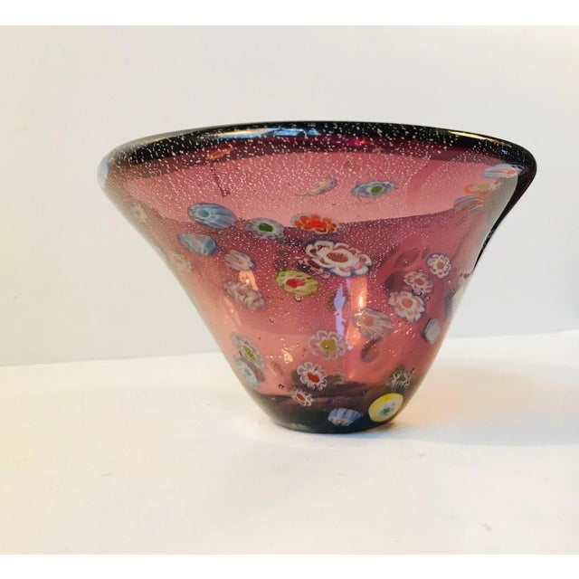 This colorful Murano glass bowl is decorated with a technique called Millefiori, meaning a thousand flowers. It was...