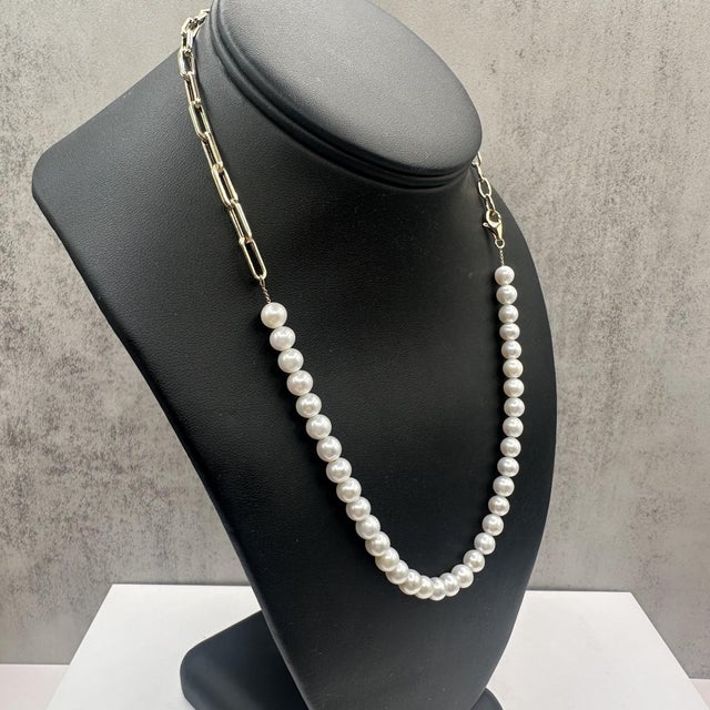 Enhance your collection with this elegant Pearl and Chain Necklace. Featuring lustrous pearls paired with a sleek chain,...