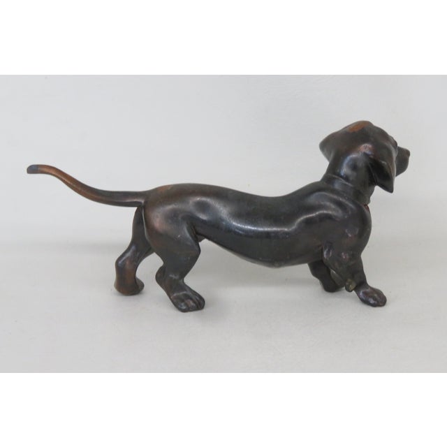 This beautiful Dachshund figurine is made of metal. This highly charming figurine is marked "Buxtehude" on the left...