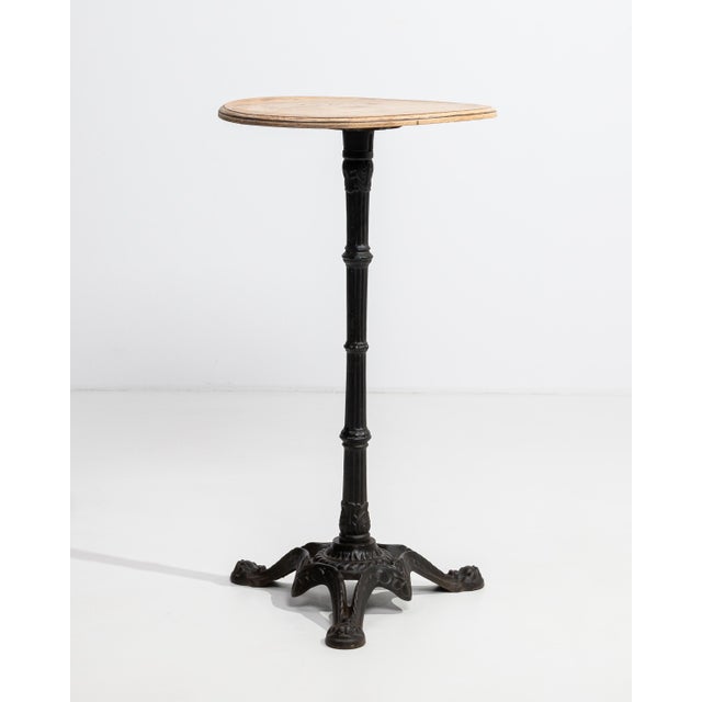 A versatile bistro table combining a sturdy iron base with a wooden top, balancing industrial durability with natural...