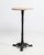 A versatile bistro table combining a sturdy iron base with a wooden top, balancing industrial durability with natural...