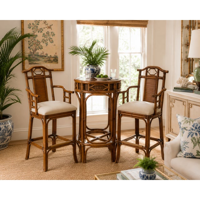 Elegant pair of vintage rattan bar armchairs featuring graceful Chinoiserie-inspired styling with gently arched crest...