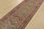 A tribal Caucasian Kazak runner hand-knotted with fine wool on a cotton foundation. This rug features a row of geometric...