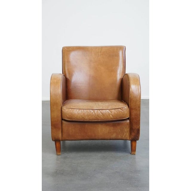 A beautiful sleek cowhide design armchair/armchair in a light cognac color. This fine, comfortable and timeless cowhide...