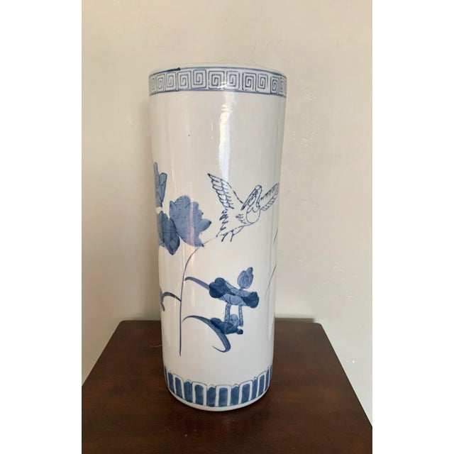 Classic blue and white Chinoiserie ceramic vase with hand painted bird and lilypad decoration. Beautiful with and without...