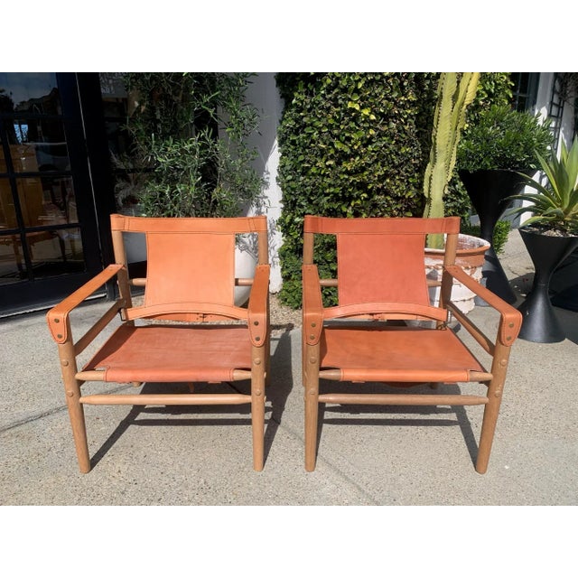 Rad leather occasional chair with buckle details. We love the rich color of this leather and the details on the wood...