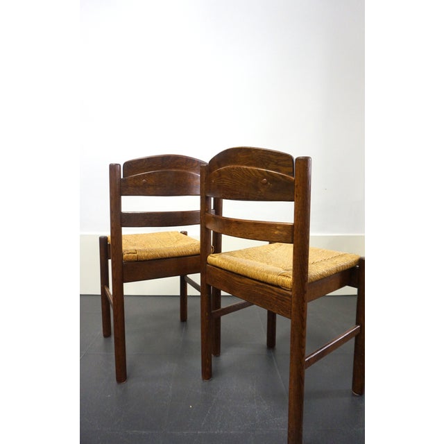 Pair of Brutalist-style chairs in solid wood with rush seats. Original design on the backrests, very stable. Well...