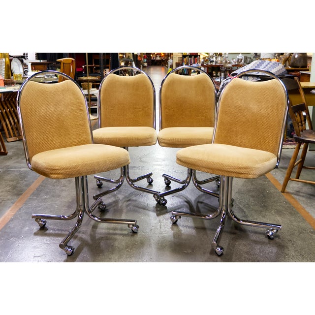 Vintage Daystrom rolling chairs featuring tubular chrome frames and upholstered seats and backs. Set of 4 with a sleek...