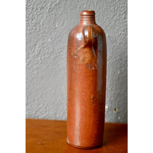 This pretty stoneware bottle is a common old ceramic. It was formerly intended for the storage and preservation of...