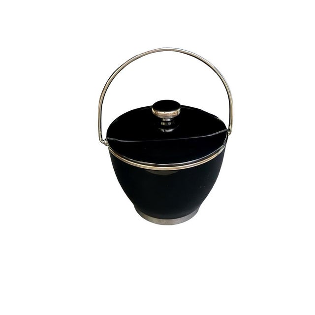 Durable ice bucket ideal for home bars or parties. Features a sleek design with a stainless steel interior and easy-to-...