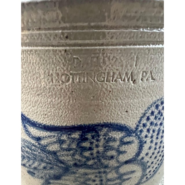 Authentic American stoneware crock featuring a charming hand-decorated cobalt blue bird motif. Crafted in classic salt-...