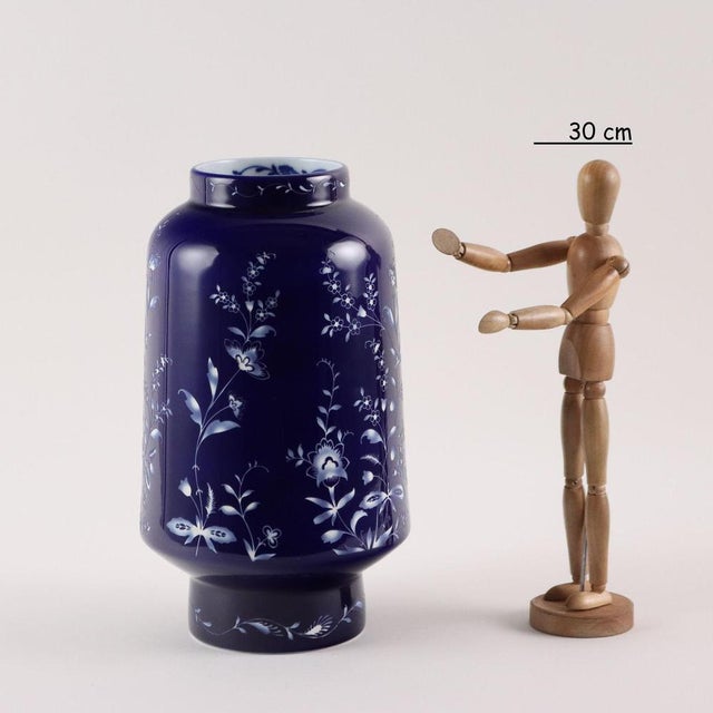 Midnight model vase in blue porcelain with engraved decoration depicting flower shoots. White interior with neck decorated...