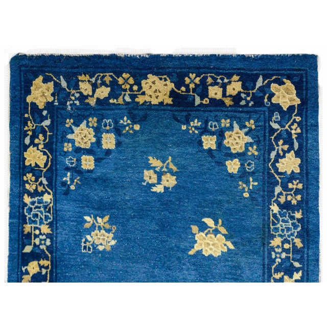 A wonderful early 20th century Chinese Art Deco rug with a central peony and chrysanthemum medallion woven in cream,...