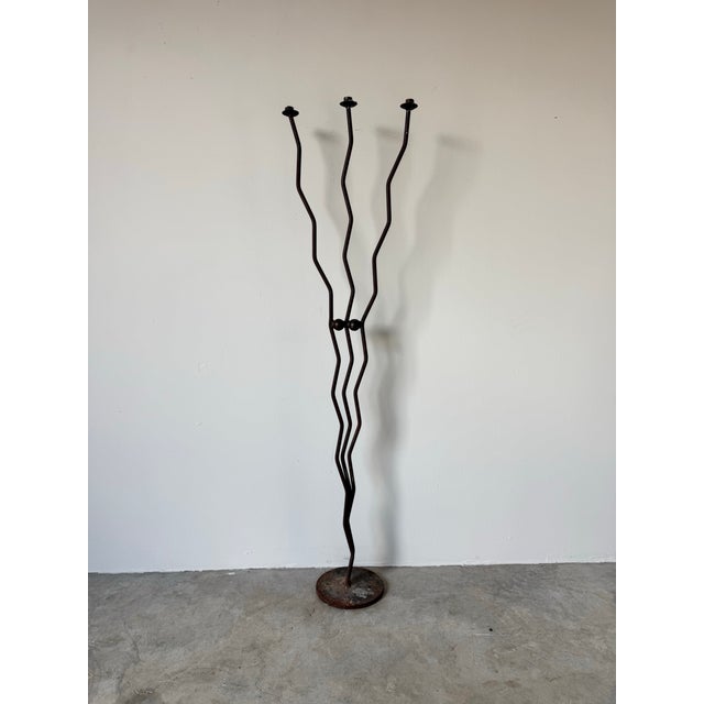 A striking vintage handmade brutalist floor candleholder crafted from wrought iron. This sculptural piece features three...