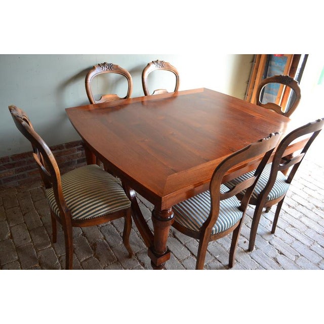 19th-century Dutch mahogany dining table with six chairs. The height of the table is 74 cm. The width of the table is 145...