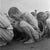 Political Prisoners Premium Rates Apply. A line of South Korean prisoners crouching on the ground, 1950. They are...