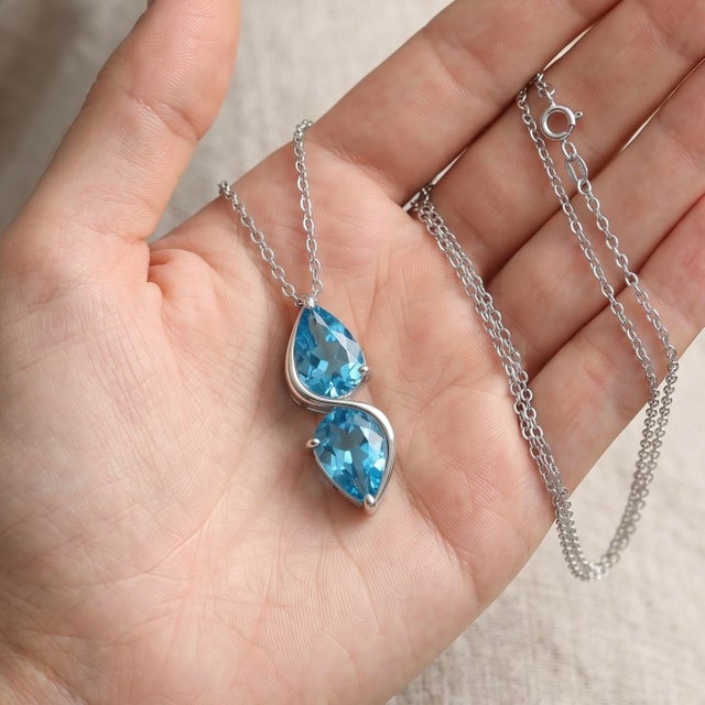 Graceful and contemporary, this elegant pendant features a beautifully flowing double pear silhouette, connected by a...