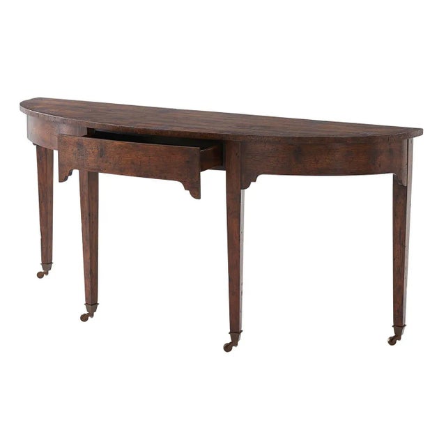 A Georgian mahogany and reclaimed oak console table, the bowfront top above a plain frieze with drawer and corner...
