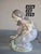 Pretty vintage Lladro figurine of a young girl gathering flowers.