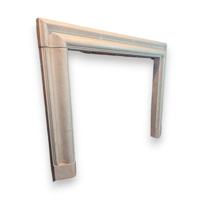 English style Bolection fireplace surround in off-white marble. The inner bolection molding is surmounted by a molded...