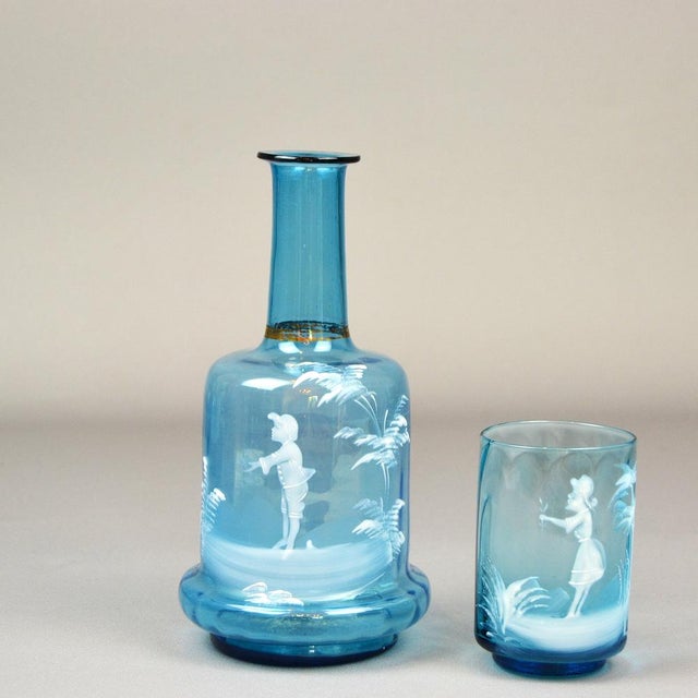 Water carafe with a glass made of beautifully colored blue glass, hand-painted decoration, ,,Mary Gregory'' glass refers...