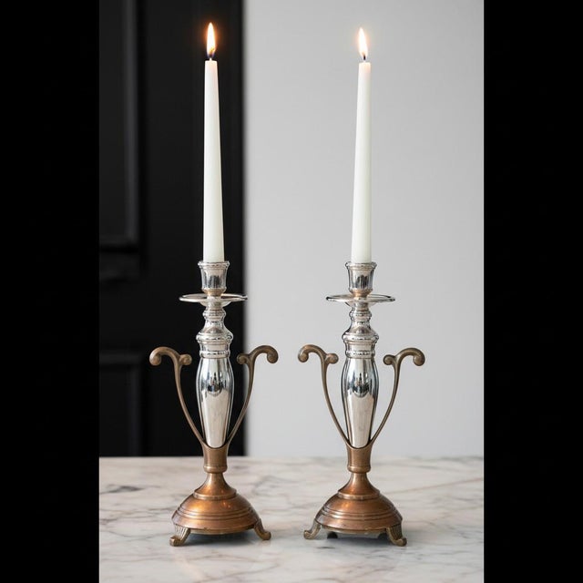 Beautiful pair of late 20th-century two-tone candlesticks featuring a polished silverplate central column set into a warm...