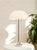 A striking vintage table lamp with a sculptural domed shade in glossy white, accented by a slender chrome stem and...