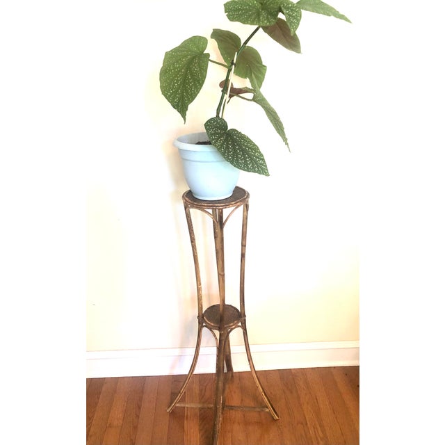 Antique English hand-formed bent bamboo two-tier plant stand. The structure features wicker bindings and a surface with...