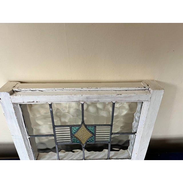 Arts and Crafts style leaded stained glass with original wood frame. Center decor made of 3 types of vintage art glass...