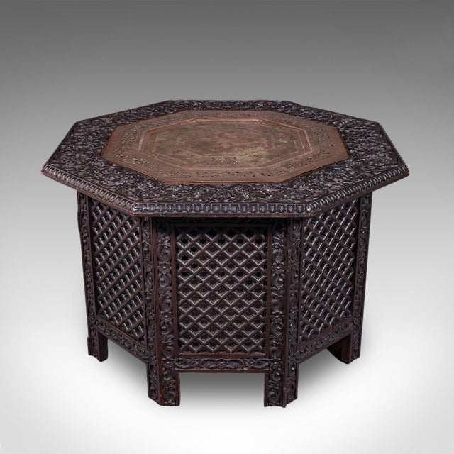 This is an antique veranda tea table. An Indian, mahogany and copper octagonal Benares table, dating to the late Victorian...